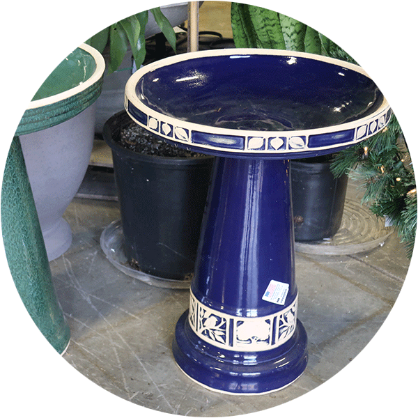 Blue ceramic bird bath with white accent designs